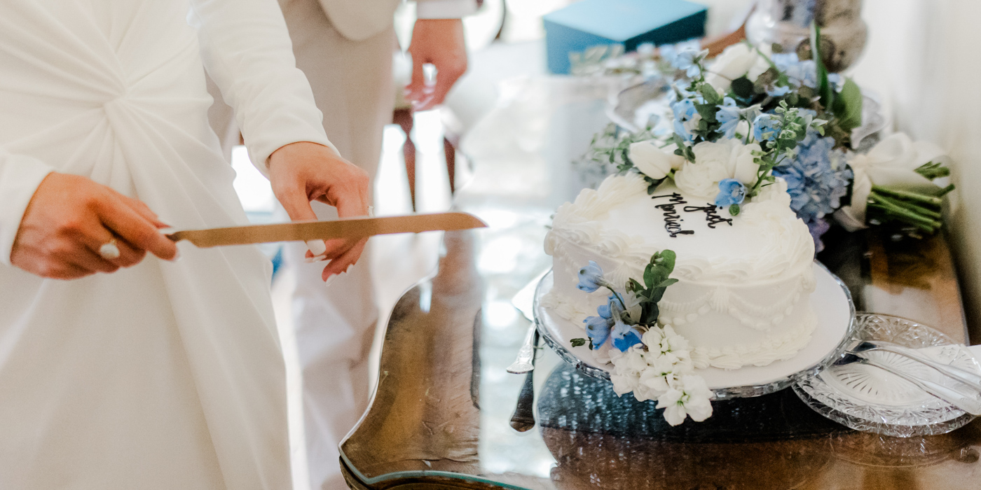 a person cutting a cake