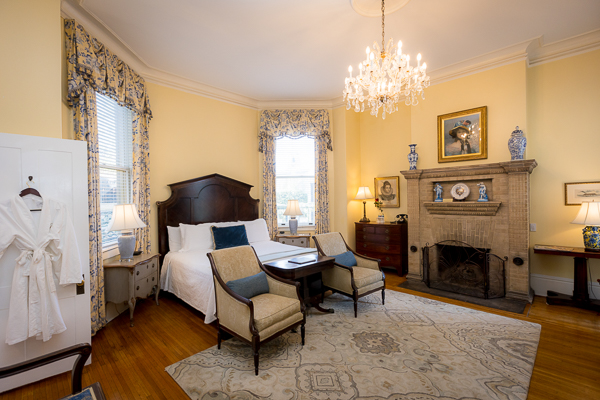 a bedroom with a fireplace and a bed
