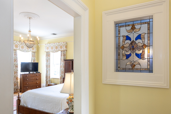 a stained glass window in a bedroom
